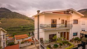 a white house with a view of a valley at House Douro Panorama Valley in Pinhão