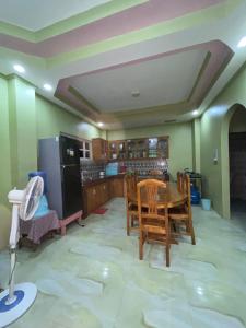 a kitchen with a table and chairs in a room at Shine and Denden Transient House-Panglao in Panglao Island