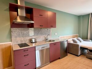 a kitchen with red cabinets and a couch in a room at Luxury Singular Blue in Santiago de Compostela +38 photos