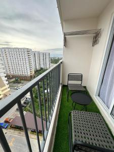 a balcony with two chairs and a table at J&A Arcadia in Lapu Lapu City