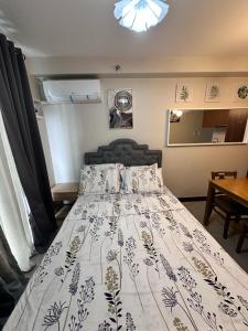 a bedroom with a bed with a white bedspread at J&A Arcadia in Lapu Lapu City +5 photos