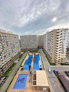 an overhead view of two large apartment buildings with pools at J&A Arcadia in Lapu Lapu City