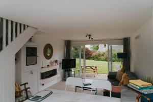 a living room with a couch and a tv at Newquay Holiday Home in Newquay