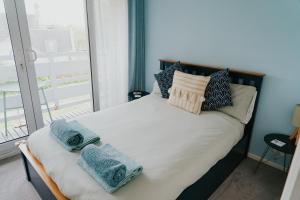 a bedroom with a bed with towels on it at Newquay Holiday Home in Newquay