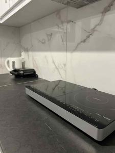 a laptop sitting on a counter in a room at Minimal Above In Karelas in Paianía +2 photos