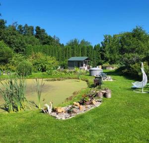a garden with a landscaping with a giraffe in the grass at Imantass in Salacgrīva