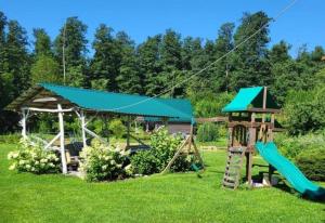 a playground with a slide and a play structure at Imantass in Salacgrīva