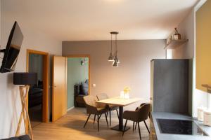 a kitchen and dining room with a table and chairs at Zum Stadtknecht-inkl. Parkplatz in Wernigerode +9 photos