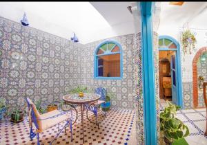 a room with a table and chairs in a room at riad la citadelle in El Jadida +15 photos