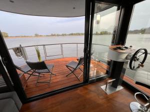 two chairs on a deck of a boat at Urlaub im schwimmenden Ferienhaus, mitten in der Natur in Kützkow +4 photos