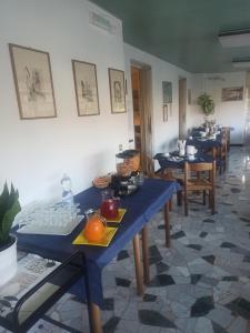a dining room with blue tables and chairs at Albergo Calcagno in Borgio Verezzi +12 photos