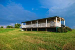 a house on a hill with a large grass field at Rustic Mt Sterling Cabin2 Near Downtown Pets OK in Mount Sterling