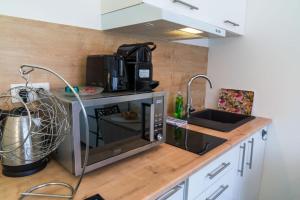 a kitchen with a microwave on a counter at Studette Croisette, proche Martinez in Cannes +2 photos