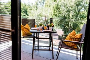 a table and two chairs on a balcony at Ferienwohnanlage Zur Himmelsleiter in Tirschenreuth