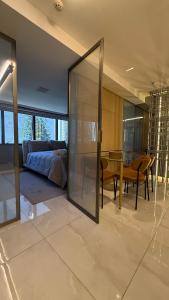 a living room with a couch and a dining room at Apartamento alto padrão dentro de hotel in Brasilia +11 photos