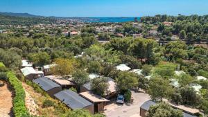 an aerial view of a village with trees and buildings at Camping Mas De Pierredon in Sanary-sur-Mer