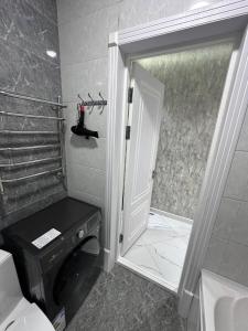 a bathroom with a toilet and a glass shower door at Heart of Samarkand, main center in Samarkand +31 photos