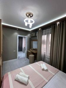 a bedroom with a large bed with two pillows on it at Heart of Samarkand, main center in Samarkand