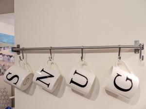 a group of white bags hanging on a rack at The Snug, Lynmouth - Uk41696 in Lynmouth