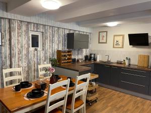 a kitchen with a wooden table and a dining room at Ferienwohnung Bodensee, Niedersachsen in Bodensee