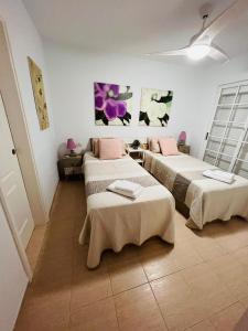 a room with two beds with towels on them at Apartamentos The Heights - Los Cristianos in Los Cristianos