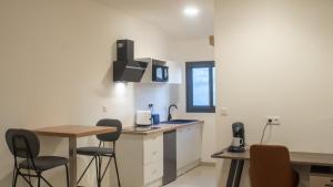 a kitchen with a table and chairs in a room at Résidence Victoria in Mamoudzou