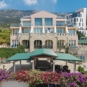 a building with a picnic table and some flowers at Spa Resort Luxury Apartments in Budva