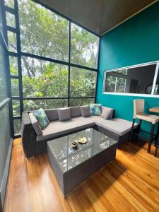 a living room with a couch and a table at The Emerald Haven in Parrita +31 photos