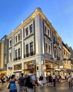 a large building with people walking in front of it at Athens Icon Collection in Athens