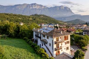 an aerial view of a house with mountains in the background at Hotel Relais Vecchio Maso in Trento