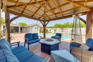 a patio with blue furniture and a swimming pool at West Covina Gem with Pool 25 Mi to Disneyland! in West Covina