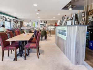 a restaurant with a wooden table and chairs at Loch Ness Drumnadrochit Hotel in Drumnadrochit