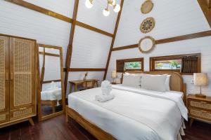 a bedroom with a large white bed in a room at Alamora Villa - New Stylish 1BR Villa, Canggu in Dalung +26 photos