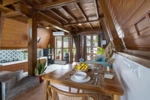 a dining room with a table with a bowl of fruit on it at Alamora Villa - New Stylish 1BR Villa, Canggu in Dalung