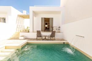 una villa con piscina e una casa di Kyma & Anemos Suites a Naoussa
