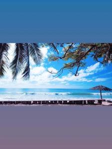 a view of the beach with an umbrella and the ocean at Villa Mangunrahe in Bira