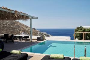 a swimming pool with a view of the ocean at Myconian Villa Collection - Preferred Hotels & Resorts in Elia Beach