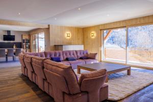 a living room with a couch and a table at La Licorne de l'Encombrette 150 m2 in Allos