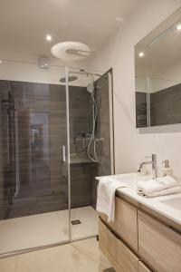 a bathroom with a shower and a sink at La Licorne de l'Encombrette 150 m2 in Allos +7 photos