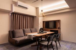 a living room with a couch and a table at Hotel TOKI 季 in Tokyo