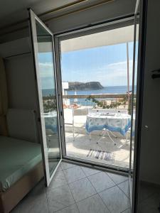a balcony with a table and a view of the ocean at Joannas Stefaneli House in Himare