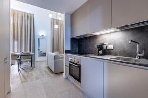 a kitchen with a sink and a counter top at Old Theatre Suites - Ischia in Valletta