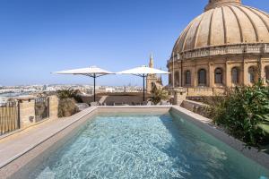 a swimming pool on the roof of a building at Old Theatre Suites - Ischia in Valletta +5 photos