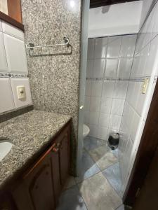 a bathroom with a shower and a sink and a toilet at Pousada Aqui é Para-Ti in Paraty