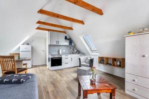 a living room with a couch and a table at Huus achtern Diek - Ferienwohnung 5 in Nordstrand