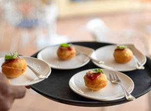 a tray with four plates of food on a table at Hotel Posa Posa in Positano