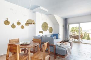 sala de estar con mesa y sofá en Apartamentos Castaví, en Es Pujols