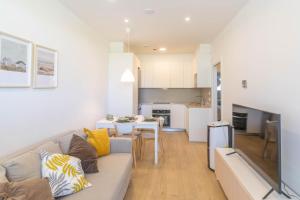 a living room with a couch and a table at Acogedor apartamento loft a 15 minutos del centro in Pamplona +24 photos