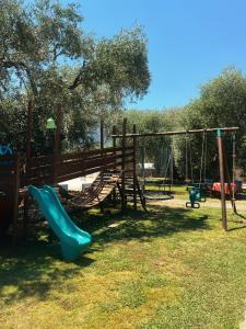 a playground with a slide and a swing at Rainbow Apartments in Skala Potamias