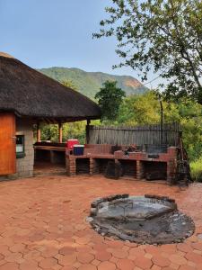 a patio with two benches and a fire pit at Inkonka Game farm in Uitsig